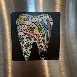 May include: A black background with a white tooth shape. The tooth is decorated with a rainbow, clouds, shamrocks, and hearts. The text "@miraclemolar" is in the bottom right corner.