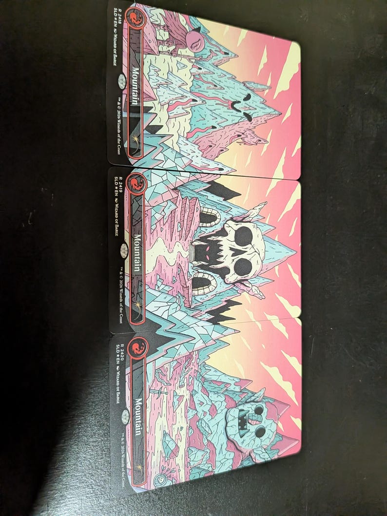 May include: Four collectible trading cards depicting a mountain landscape with a skull and other fantasy elements. The cards have a pink, blue, and white colour scheme with the word "Mountain" printed on them. The cards are from the "Wizard of the Coast" series.