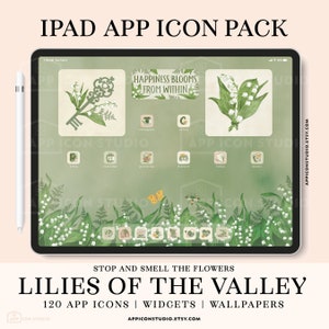 May include: An iPad displaying a custom app icon pack with a floral theme. The screen shows app icons, widgets, and wallpapers with lily of the valley illustrations. Text on the screen reads "Happiness Blooms From Within" and "Lilies of the Valley". A stylus is visible.