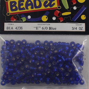 May include: A package of blue seed beads labeled "E" 6/0 Blue. The package is marked with the item number BEA 4236 and contains 3/4 oz of beads. The package has a black header with the words "BEAD it" in a colorful design.