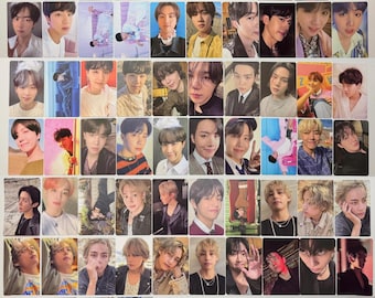 May include: A collection of rectangular photo cards featuring various portraits of members of the musical group BTS. The cards display individual close-ups, group shots, and candid poses in diverse lighting, colour palettes, and settings, arranged in a grid.