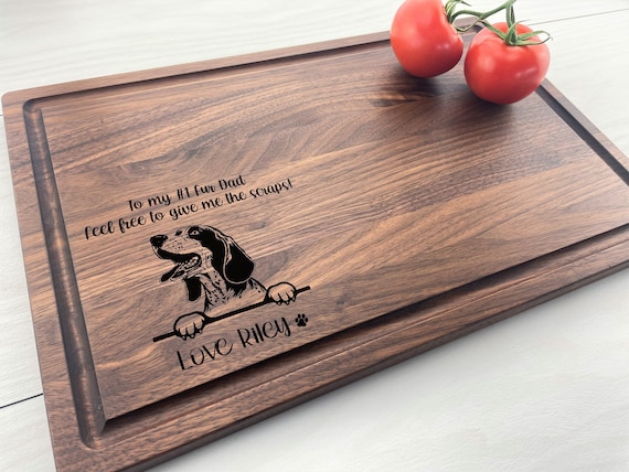 A beautifully engraved Bluetick Coonhound portrait on a cutting board is hyper-specific breed love that dog owners lose their minds over.