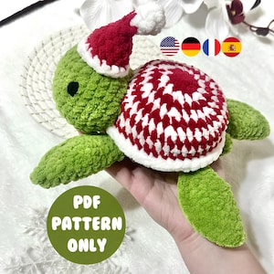 May include: A green crocheted turtle wearing a red and white Santa hat. The turtle's shell is red and white. The image includes a green circle with the text "PDF PATTERN ONLY".