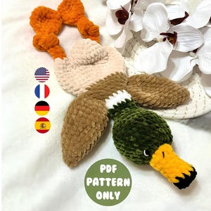May include: Crochet pattern for a plush duck toy. The duck is made with brown, beige, green, and orange yarn. The pattern is available as a PDF download.