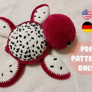May include: Crocheted dragon fruit turtle amigurumi toy pattern in PDF format. The pattern is available in English and German. The toy is red, white, and black.