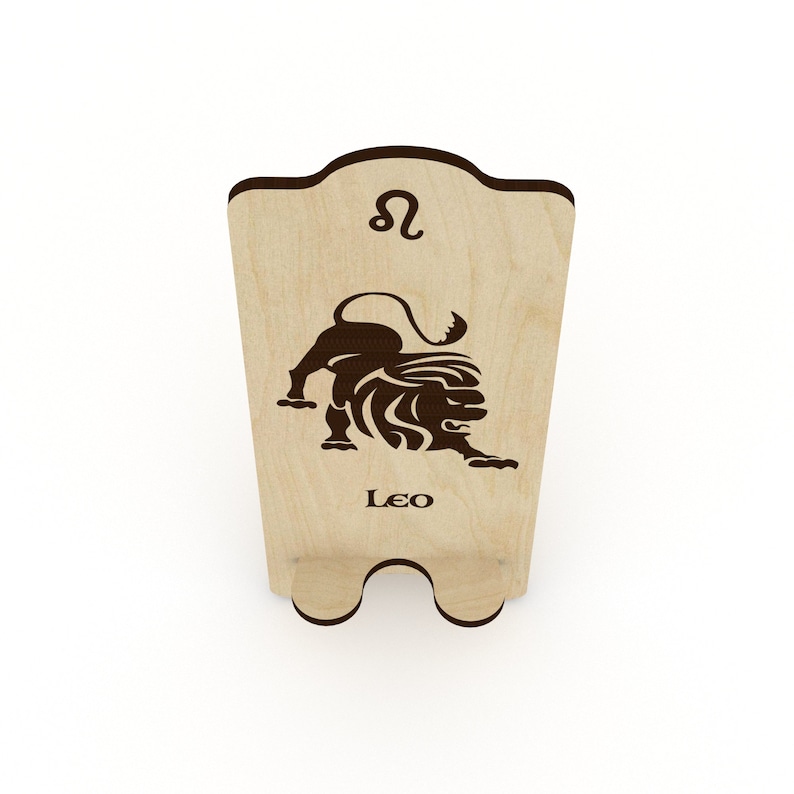 May include: Wooden phone stand with a laser-cut design of the Leo zodiac symbol and the word "Leo".