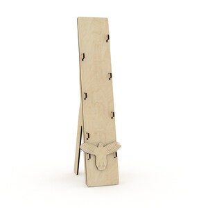 May include: A wooden display stand with a bird cutout and five slots for holding items. The stand is made of light brown wood and has a simple, rustic design.