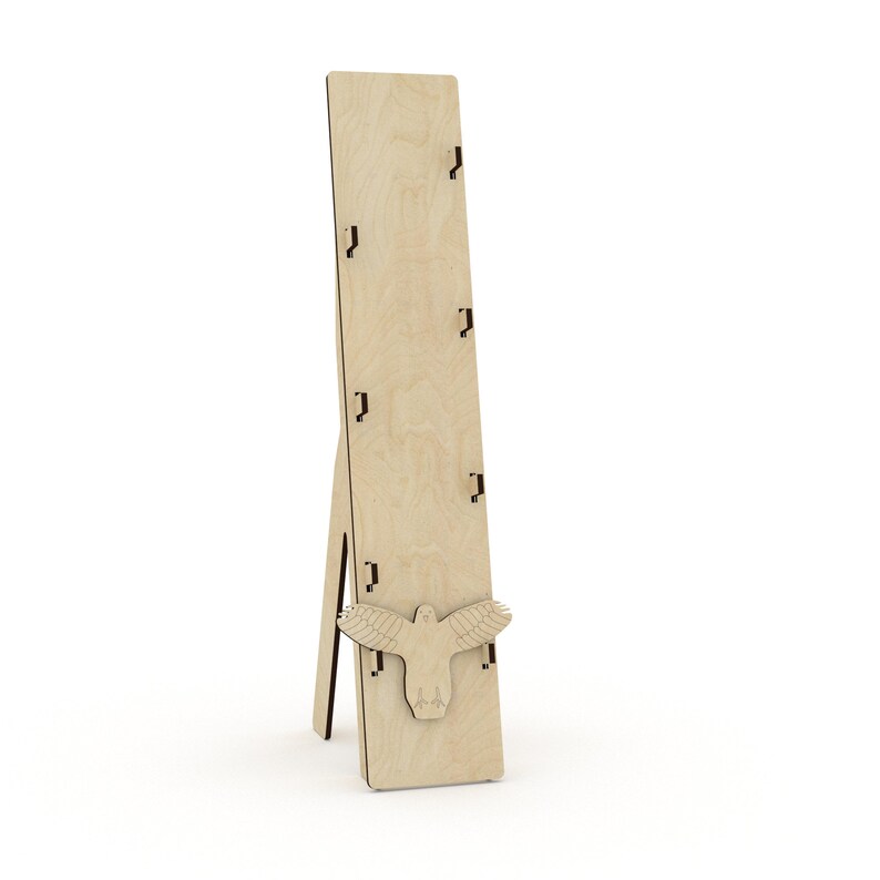 May include: A wooden display stand with a bird cutout and five slots for holding items. The stand is made of light brown wood and has a simple, rustic design.
