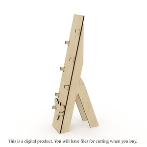 May include: A wooden easel with a bird design. The easel has four shelves for displaying items.