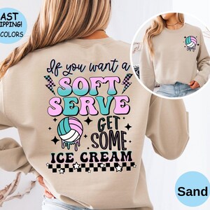 May include: A tan sweatshirt with a volleyball graphic and the text "If you want a soft serve get some ice cream".
