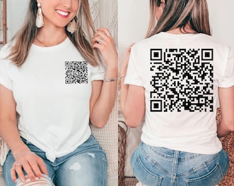 May include: A white t-shirt with a black QR code printed on the front and back. The shirt is being worn by a person.