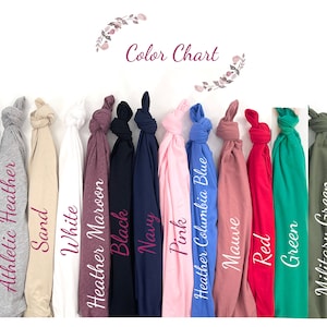 May include: A color chart displays a variety of t-shirt colors, including heather dark gray, athletic heather, sand, white, heather maroon, black, navy, pink, heather Columbia blue, mauve, red, green, military green, and ice blue. The text "Color Chart" is at the top.