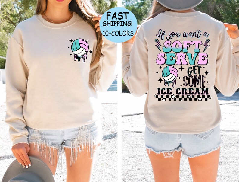 May include: A light beige sweatshirt with a volleyball graphic on the front and the text "If you want a SOFT SERVE GET SOME ICE CREAM" on the back. The text is in a retro style with pink, blue, and green colors.
