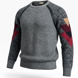 May include: A long-sleeve crew neck sweater in a heathered gray knit. The sleeves feature black raglan seams, a geometric pattern with burgundy and black triangles, and a tan triangular patch on the upper arm. The collar, cuffs, and hem are ribbed.