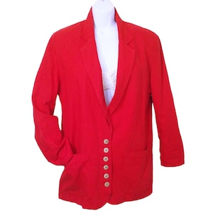 May include: A red linen blazer with a single button closure and two patch pockets. The blazer has a relaxed fit and a slightly longer length.