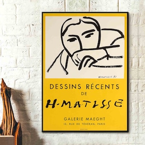 Könnte beinhalten: Ein gelber und weißer Poster mit einer Schwarzweiß-Zeichnung eines Gesichts. Der Text auf dem Poster lautet "DESSINS RÉCENTS DE H-MATISSE" und "GALERIE MAEGHT 13, RUE DE TÉHÉRAN, PARIS".