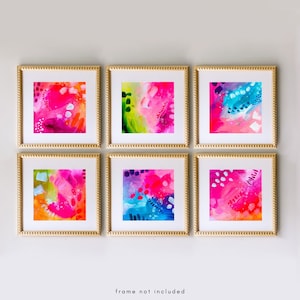 May include: Six framed abstract art prints with gold frames. Each print features a vibrant mix of pink, blue, green, and orange brushstrokes and shapes. The text "frame not included" is at the bottom.