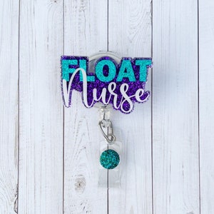 May include: A purple and teal glitter badge reel with the text "FLOAT NURSE" on it. The reel is attached to a clear retractable badge holder with a teal glitter ball on the end.