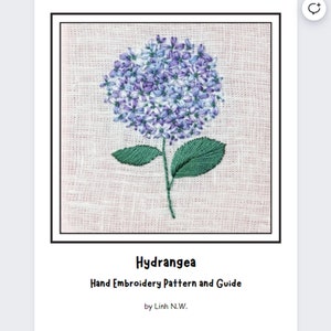May include: A hand embroidery pattern and guide for a hydrangea flower. The pattern features a purple hydrangea with green leaves on a linen background. The title "Hydrangea" and "Hand Embroidery Pattern and Guide" are printed below the image. The text "by Linh N.W." is printed below the title.