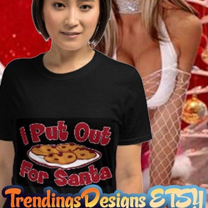 May include: A black t-shirt with the text "I Put Out For Santa" in red lettering. The text is accompanied by a cartoon image of a plate of cookies.