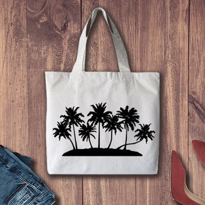 May include: A white tote bag featuring a black silhouette of palm trees on an island. The bag has long handles.