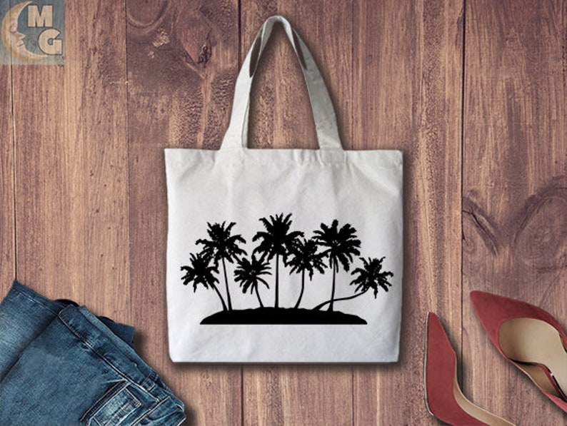 May include: A white tote bag featuring a black silhouette of palm trees on an island. The bag has long handles.