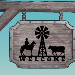 May include: A wooden sign with a metal frame and a rustic finish. The sign features a silhouette of a cowboy riding a horse, a windmill, and a cow. The sign says "WELCOME" in black lettering.