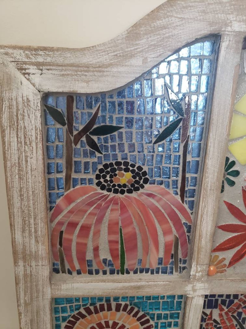 Mosaic stained glass flowers in a window.