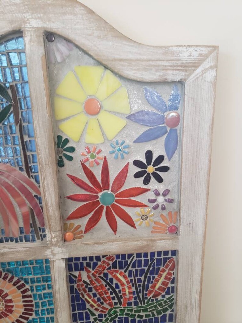 Mosaic stained glass flowers in a window.