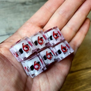 d6 dice set with white skull inside and red numbers