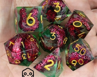 May include: Set of seven polyhedral dice with a green and clear resin base, featuring red octopus tentacles and gold numbering. The dice are designed for tabletop gaming and include a d4, d6, d8, d10, d12, d20, and a percentile die.