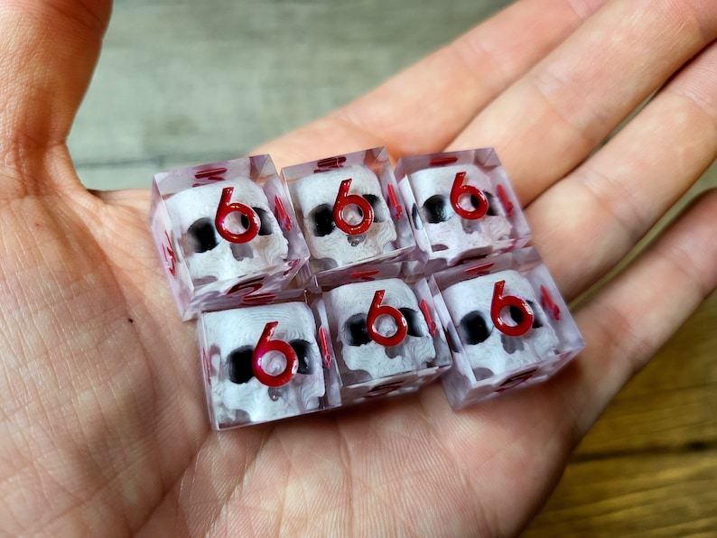 d6 dice set with white skull inside and red numbers