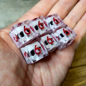 d6 dice set with white skull inside and red numbers