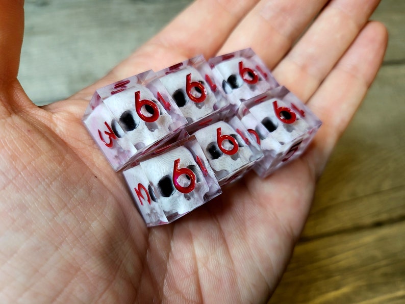 d6 dice set with white skull inside and red numbers