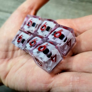 d6 dice set with white skull inside and red numbers