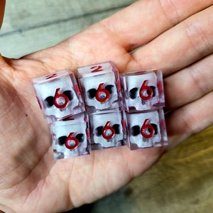 d6 dice set with white skull inside and red numbers