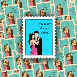 May include: A blue and white patterned background with a repeating image of a couple dancing. The couple is wearing a pink dress and a black suit. The image is surrounded by a white border with a blue and white patterned edge. The text "you're my destiny, cohen." is printed in white on a blue background.