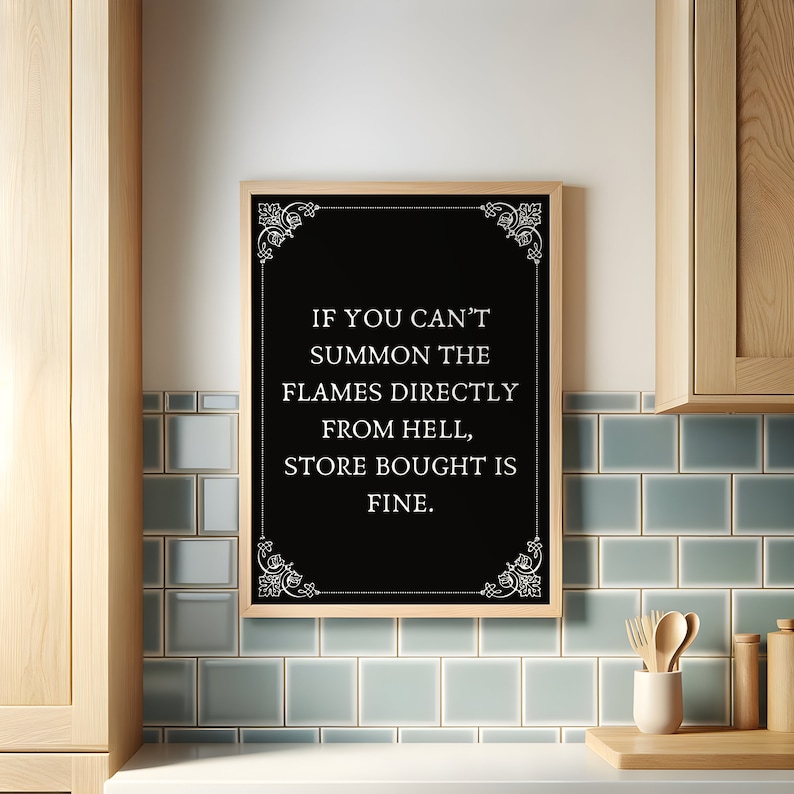 May include: A black framed chalkboard sign with white text and decorative flourishes. The text reads "If you can't summon the flames directly from hell, store bought is fine."
