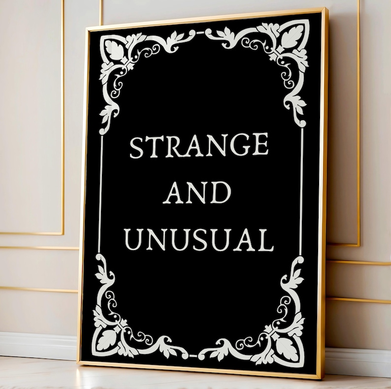 May include: Black and white framed print with a decorative border and the text "STRANGE AND UNUSUAL".