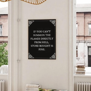 May include: Black and white framed print with a white background and black text that reads "IF YOU CAN'T SUMMON THE FLAMES DIRECTLY FROM HELL, STORE BOUGHT IS FINE."