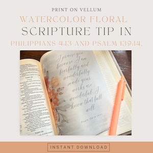 May include: A vellum sheet featuring a watercolor floral design and the text "I praise you because I am fearfully and wonderfully made your works are wonderful I know that full well" placed inside an open book next to an orange pen.