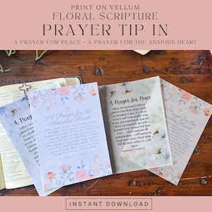 May include: Three translucent vellum sheets featuring floral borders and printed text titled A Prayer for the Anxious Heart and A Prayer for Peace. The sheets are displayed on an open book, showcasing religious prayers with soft watercolor flowers.