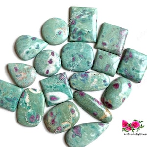 May include: A collection of 15 green and pink ruby zoisite cabochons in various shapes and sizes. The stones have a mottled green and white pattern with pink inclusions.