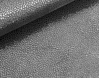 May include: Close-up of a gray textured leather material with a pebbled surface.