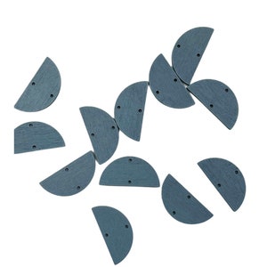 May include: A collection of 12 gray wooden half-circle shapes with two holes each. The shapes are scattered on a white background.