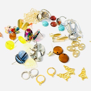 May include: Assortment of earring findings and components, including gold-tone, silver-tone, and wooden pieces. There are also several different types of earring backs, including post backs, lever backs, and clip-on backs.