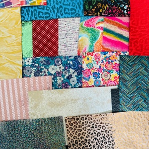 May include: A collection of colorful fabric swatches with various patterns, including floral, geometric, animal print, and tie-dye. The swatches are arranged in a grid pattern and are perfect for crafting or scrapbooking.