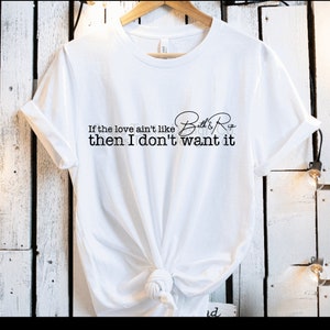 May include: White t-shirt with black text that reads "If the love ain't like Bell & Ross then I don't want it".