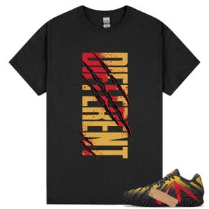 May include: Black t-shirt with the word "DIFFERENT" in a vertical design, featuring red claw marks. A pair of black, yellow, and red sneakers with a tan accent are in the image.