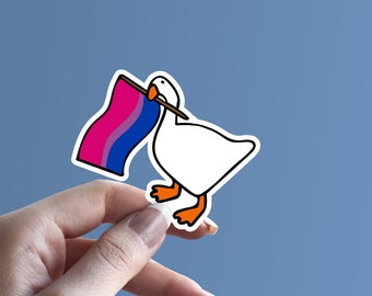 May include: A white goose holding a pink, blue, and purple bisexual pride flag. The goose is cartoon-style and has a black outline.